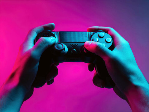 Hands Holding a Game Controller with Colorful Gradient Lighting for Entertainment Purposes