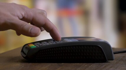 Through NFC advancements, a hand places a smartphone by the payment reader, inputs a PIN on the POS device, and swiftly conducts a secure payment transaction. - Powered by Adobe