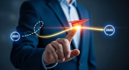 Concept of business transformation and future planning from 2025 to 2026 showing finger launching red arrow toward goal, representing leadership, direction, and strategic roadmap for success