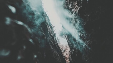 Sunlight through canyon gorge, misty waterfall. Nature travel adventure background