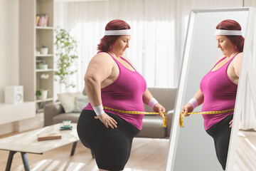 Overweight woman holding a measure tape