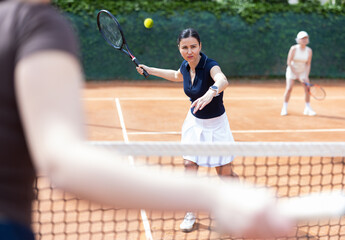 Girls participate in final tennis match, students of sports school practice skills and mastery...