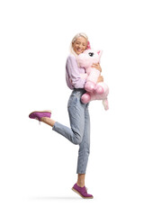 Happy woman hugging a big pink unicorn