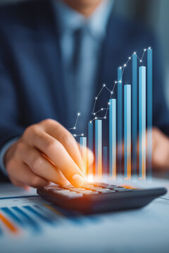 Financial growth and accounting analysis concept with businessman using calculator and virtual bar chart. Perfect for business success, revenue growth, finance report, and investment planning.