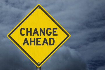 Change Ahead yellow warning sign with stormy sky