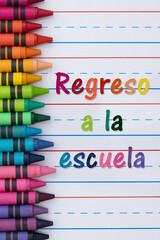 Back to School  Regreso a la escuela with crayons with ruled loose leaf paper