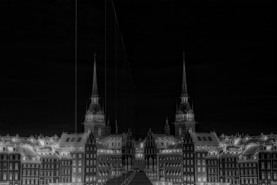 Fototapeta The old town in Stockholm reflecting in glas at night in black and white.