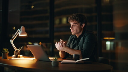 Confident specialist video call by laptop at night office closeup. Man talking 