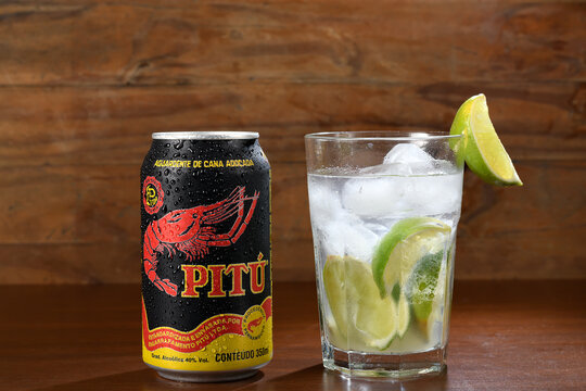 Can of Pitu and a glass with Caipirinha Refreshing cocktail with Brazilian cacha&ccedil;a
