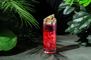 Refreshing red cocktail featuring tequila, liqueur, lime juice, and ginger beer served in a vibrant...