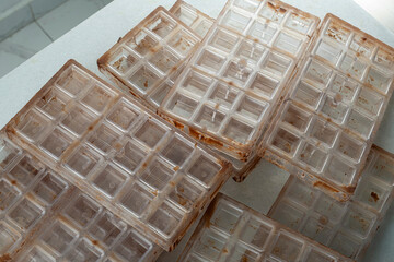 Dirty plastic molds for making chocolate squares_top view.