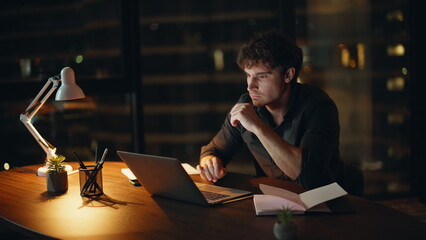 Shocked freelancer losing job reading laptop email at night home closeup.