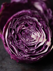 Obraz premium Sliced Red Cabbage Arranged in a Natural Mandala Pattern Showcasing Vibrant Colors and Intricate Details on a Dark Surface
