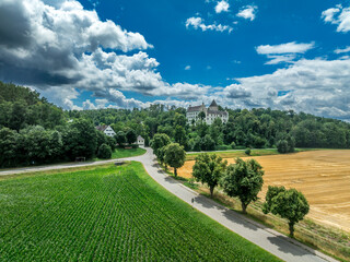 Aerial view of Kronwinkl castle in Bavaria Germany with large round keep and palace buildings