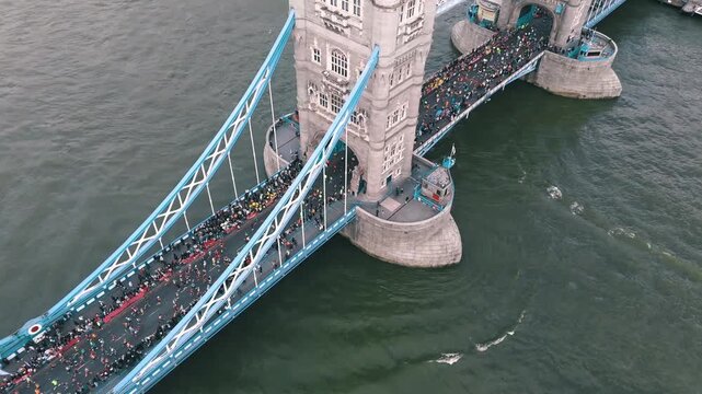 Runners crossing Tower Bridge with London.