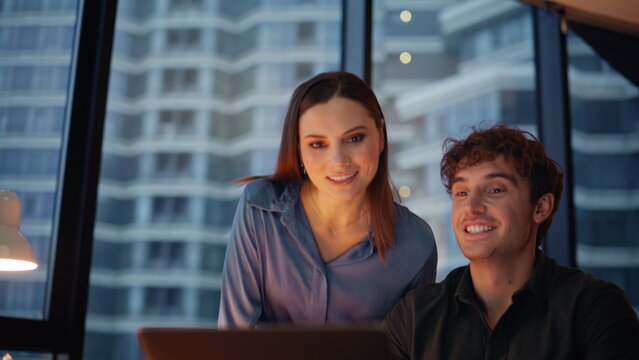 Colleagues talking virtual meeting at evening office closeup. Smiling coworkers