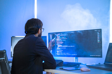 Diverse team of AI developers collaborating in a modern office. Indian male leading a discussion...