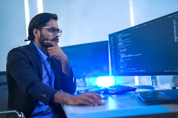 Diverse team of AI developers collaborating in a modern office. Indian male leading a discussion...