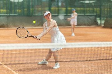 Woman participate play tennis two on two with female companion. Friendly tournament, sports...