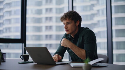 Stressed loser reading laptop bad news at contemporary workspace closeup.