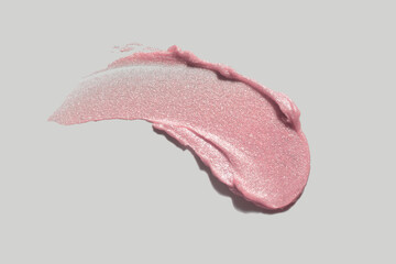 Lipstick or glitter highlighter sparkle pink peach texture smudge isolated on gray