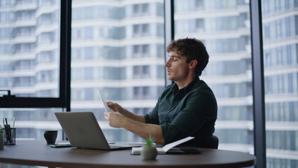 Businessman talking online negotiations sitting office. Smiling professional