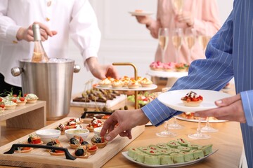 People with different appetizers at buffet, closeup