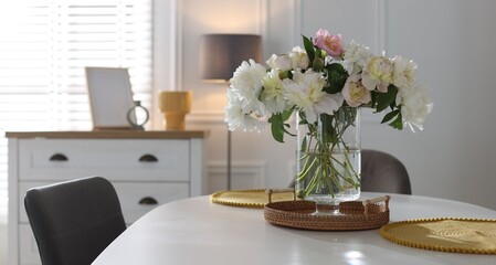 Beautiful table setting with vase of flowers in dining room, space for text