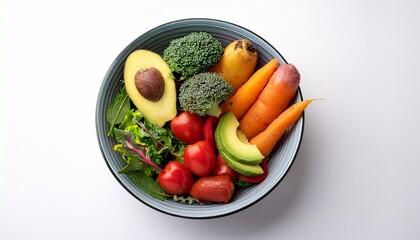 a colorful bowl of fresh vegetables including avocado broccoli tomatoes sweet potatoes and greens arranged beautifully on a white surface