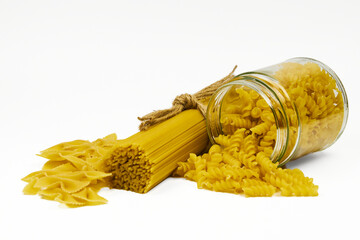 Various types of raw pasta in different containers in an isolated shot, with copy space on a white...