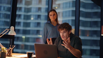 Annoyed business people videocalling frustrated documents mistake at dark office
