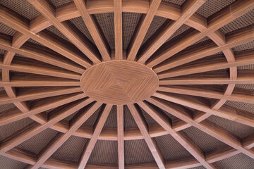 a close-up view of a circular wooden ceiling design, likely from an interior space. The ceiling...