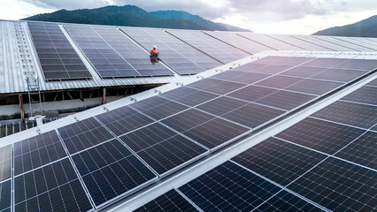 technician installs a large photovoltaic system on an industrial rooftop. ESG investment, and the...