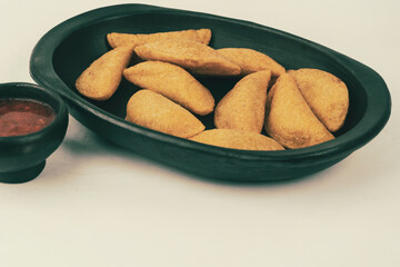 Colombian empanada with spicy sauce 