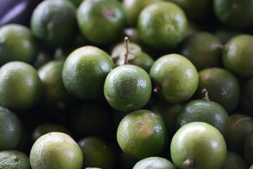 Fresh green limes from the garden with a refreshing aroma, perfect for cooking and drinks.