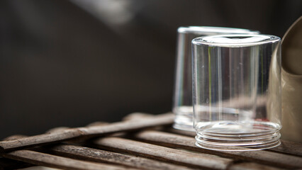 Close up of empty glass on wooden table. Selective focus.