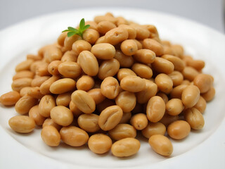 Soybeans, a type of legumes, used as a staple food, and a high source of protein, stacked on a white ceramic plate in the background