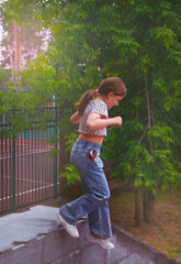 Happy young girl enjoying walking, jumping, free running. Freestyle. Freedom and carefree....