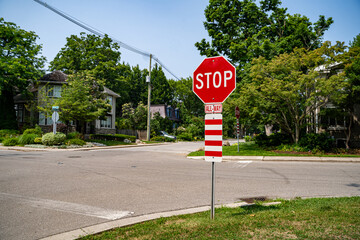 View of stop all way warning sign on roadside.
