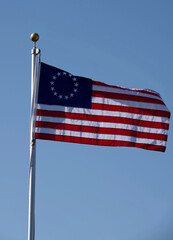 Historic American Union Flag waving under blue sky