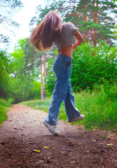 Happy young girl enjoying walking, dancing, jumping. Freestyle. Freedom and carefree....