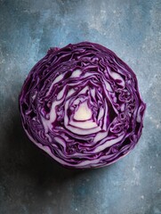 Obraz premium Sliced Red Cabbage Forming a Natural Mandala Pattern on a Textured Surface With Open Top View