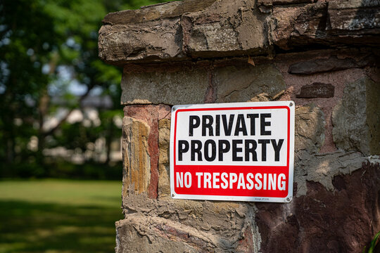 View of private property no trespassing sign at garden entrance.