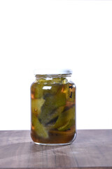 canned cashew and orange in a glass jar isolated, cashew halves in syrup, yellow fruit dessert, canned nectarine compote, sweet peeled cashew and orange slices in syrup on a white background