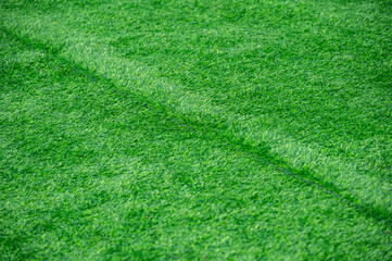 Wrinkled green artificial turf used for covering sport arena or garden. Artificial grass are made...