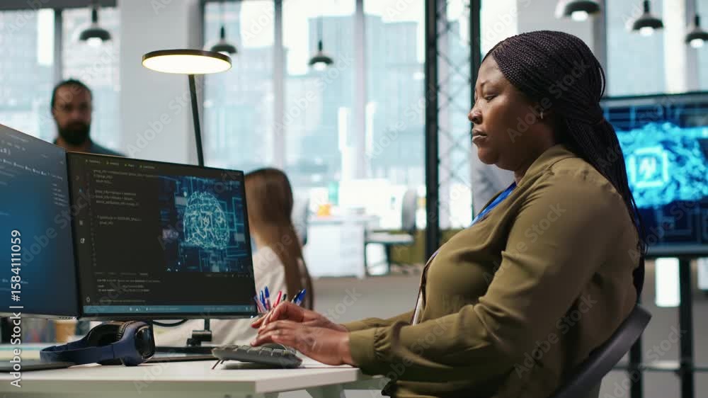 Poster computer scientist in startup office reviewing ai system metrics, monitoring performance dashboards.