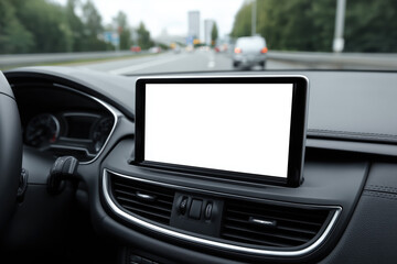 Close-up of a car dashboard featuring a blank touchscreen display while driving through an urban road, perfect for showcasing navigation app mockups, smart vehicle interfaces