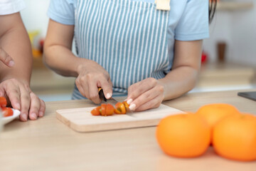 Healthy Cooking: Woman slicing tomatoes in a bright kitchen