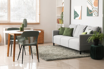Stylish comfortable living room with sofa, table and shelving unit