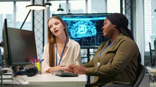 Employee helping upset friend in need at work, comforting coworker, resting hand on her shoulder. Sad young girl talking to kind colleague at desk, receiving emotional support, camera A